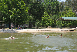 Enjoy a swim at the sandy beaches, at Picnic Point Caravan Park